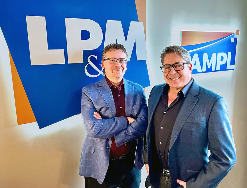 Photo of Andy Collins and Mike Ancillotti in front of an LP&M sign